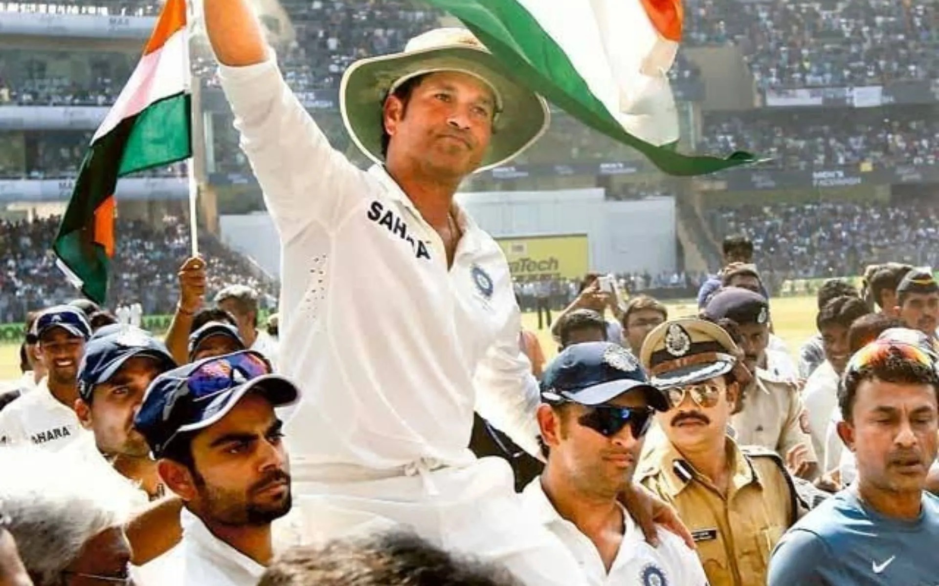 Sachin Tendulkar carried on his teammates' shoulders for a farewell lap, tricolour flags flying