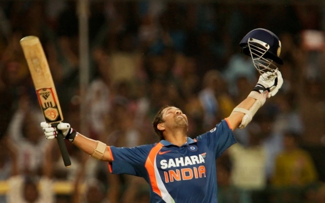 Sachin Tendulkar raises his arms to the sky after reaching 200 not out at Gwalior, 2010