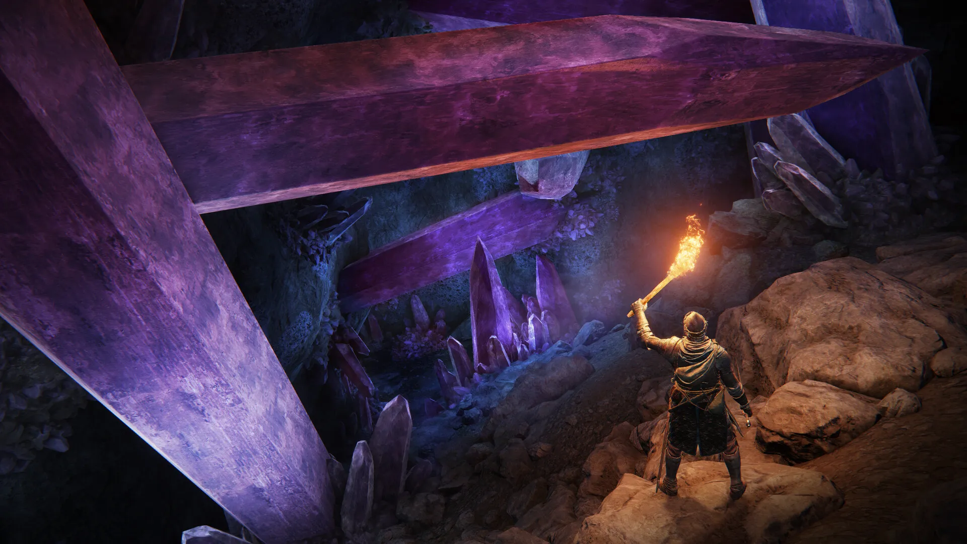 A player holding a torch in a dark cave lit by purple crystals