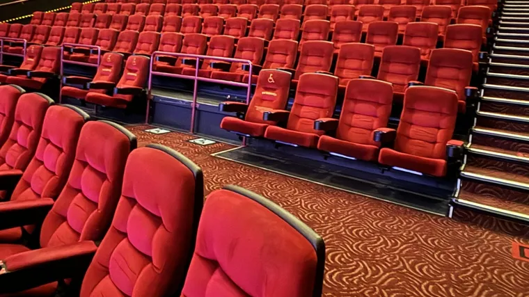 Rows of empty red cinema seats