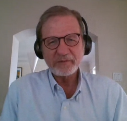 Paul Eggert on a video call, wearing headphones, at home
