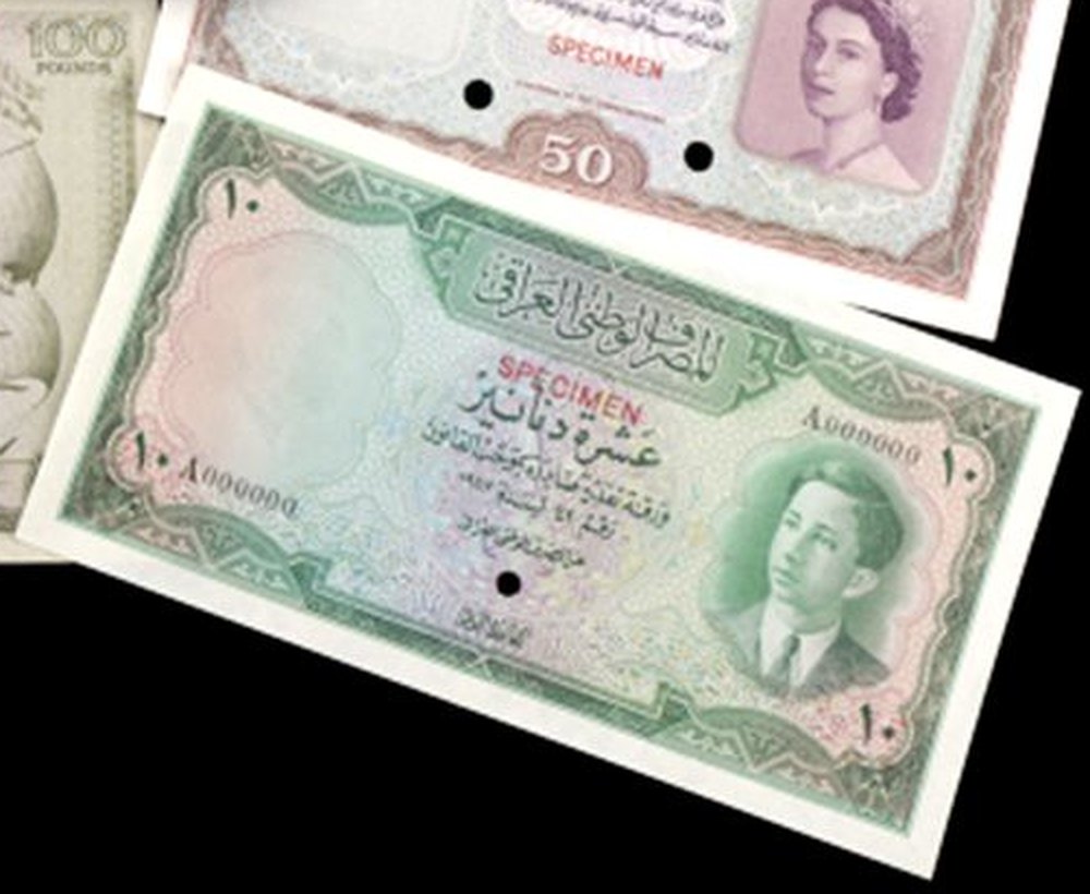 A green and pink Iraqi ten dinar note with Arabic lettering and a portrait of a boy in a jacket and tie on the right, stamped SPECIMEN in red with a punched hole.